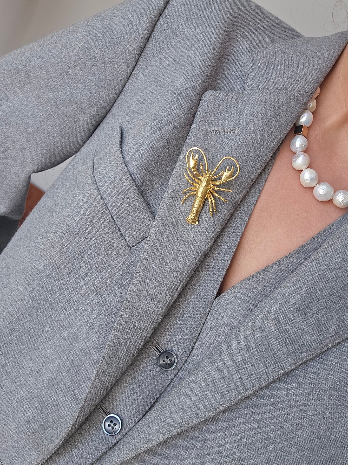 Gold-colored lobster brooch pin
