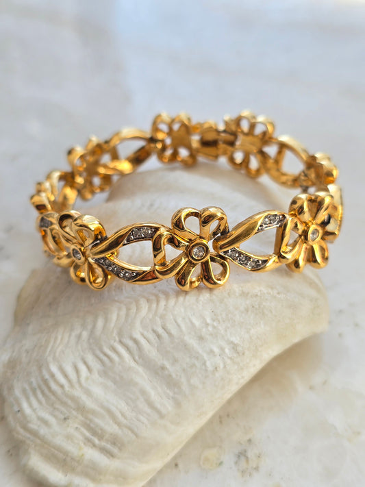 Vintažinė paauksuota Nina Ricci apyrankė bantukai