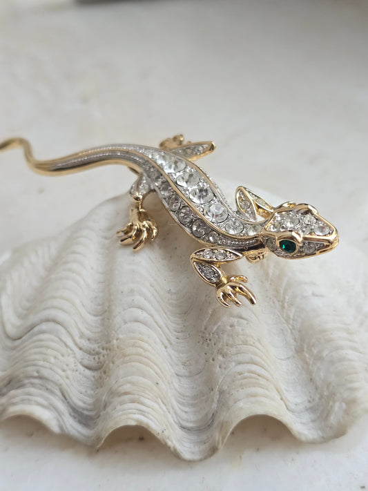 Aukso spalvos sagė su stiklo kristalais driežas